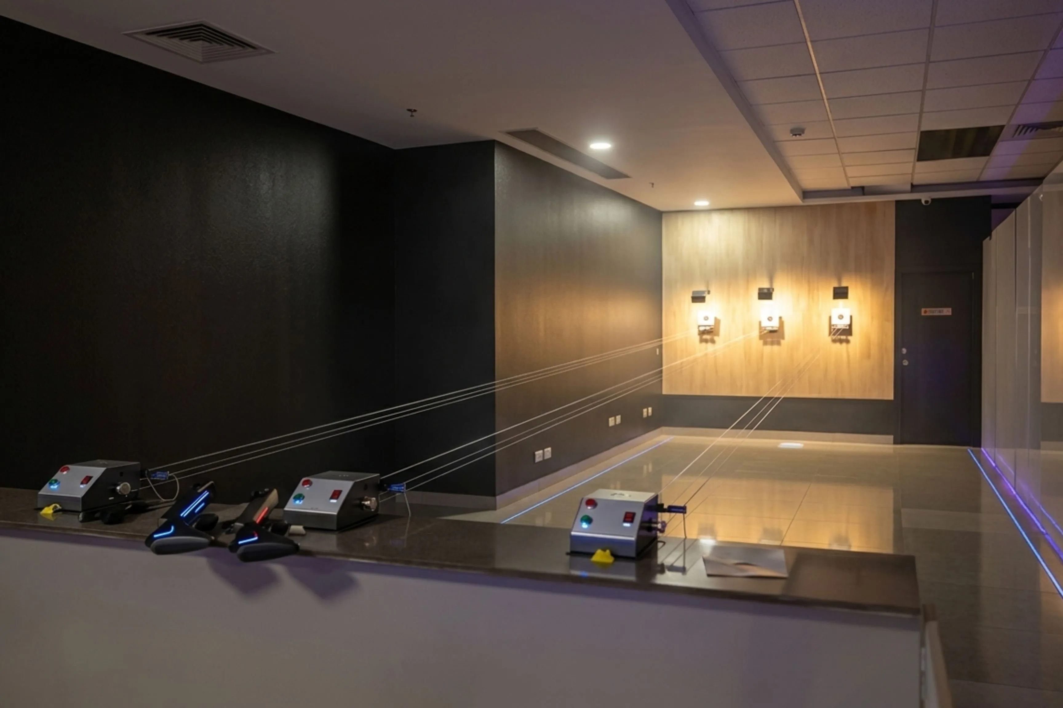 Indoor shooting range stations with scoring equipment and targets at Game Xtreme