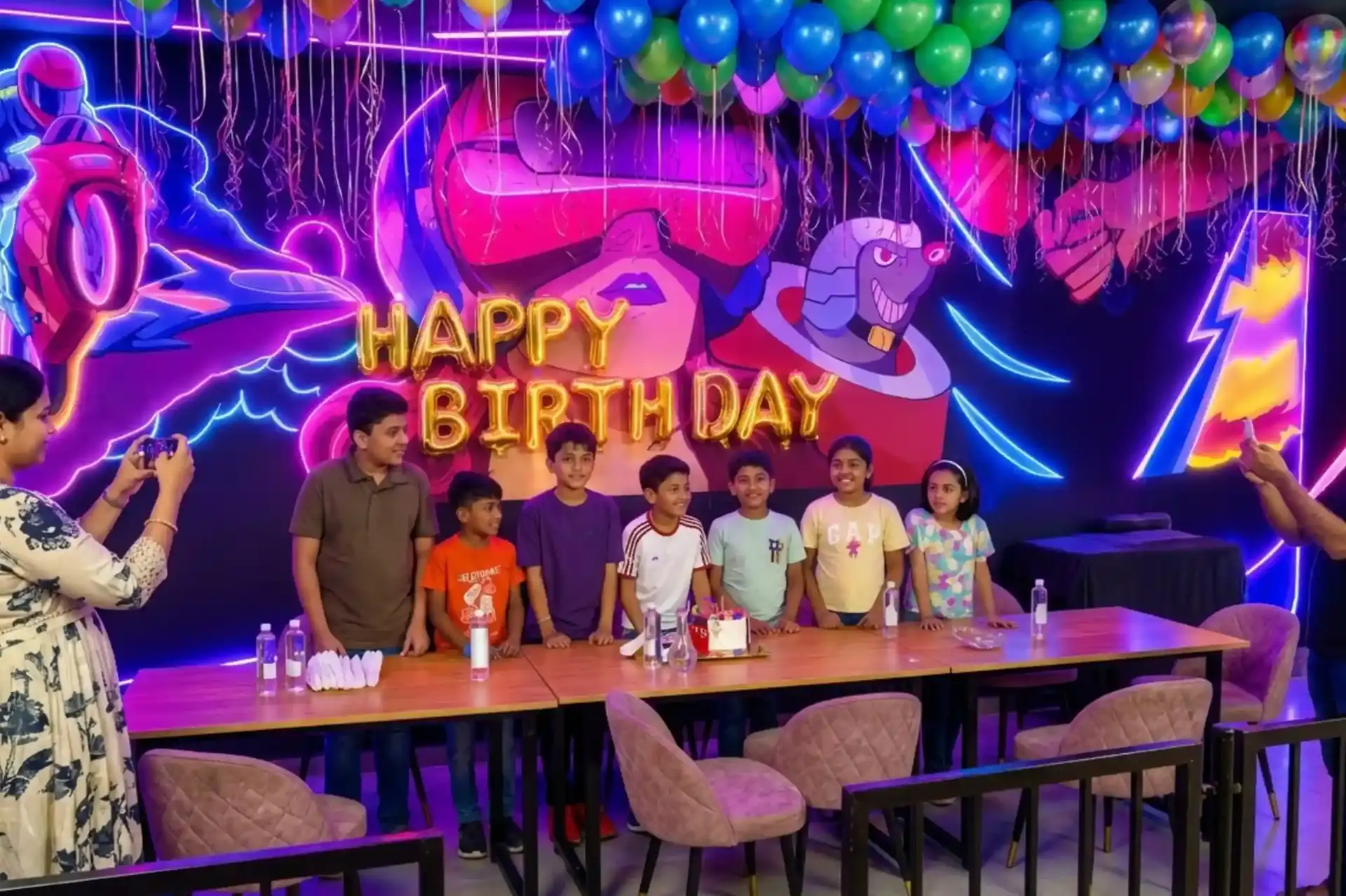 Kids and families celebrating a birthday party at Game Xtreme with balloons and decorations