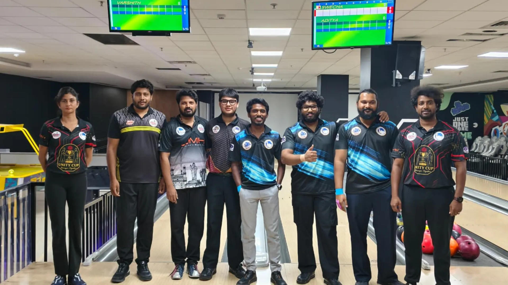 Tournament bowlers posing beneath live scoring monitors during the Telangana State Ranking Tournament at Game Xtreme