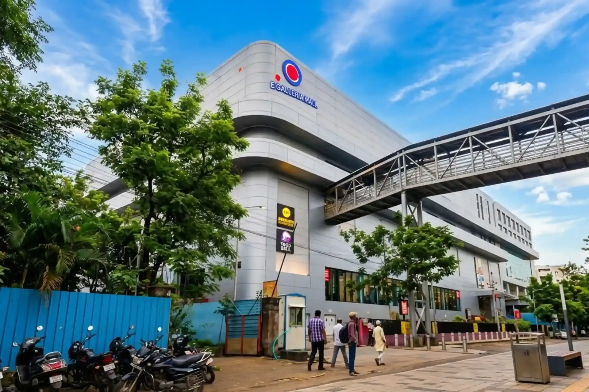 E Galleria Mall street-level exterior view with mall signage, pedestrian walkway bridge, and entrance on HITEC City Road, Madhapur